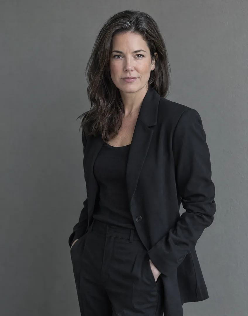 Isabel Carrow, Partner, M&A: woman in her forties, black blazer