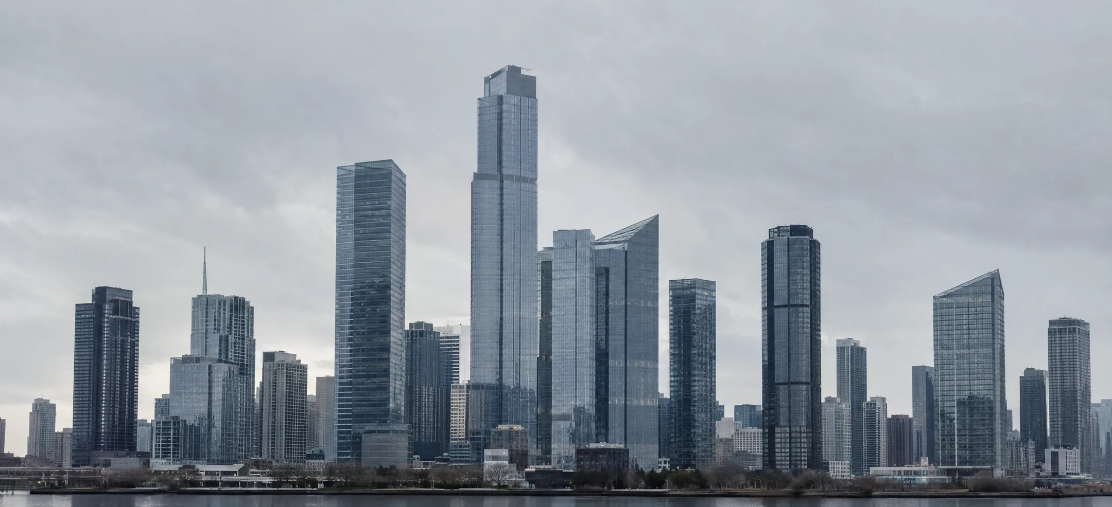 A wide city skyline of glass towers, monochrome
